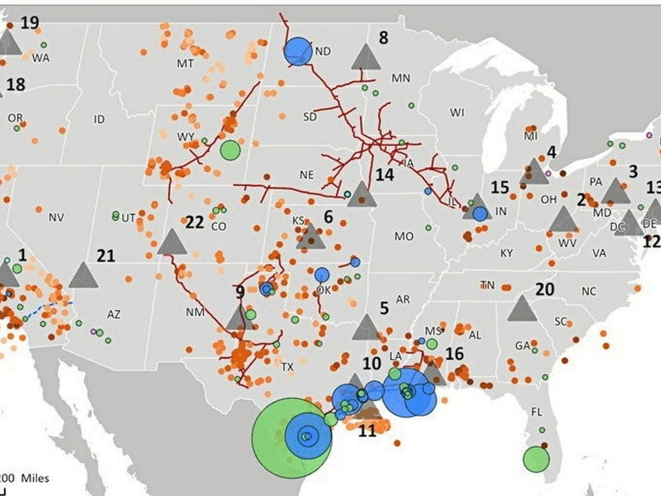 Map of the United States with colored markers: orange dots, blue and green circles, red fault lines, and gray triangles marking various geological features or events.